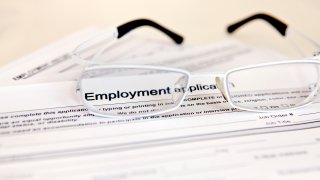 A photo of a job application with glasses on it