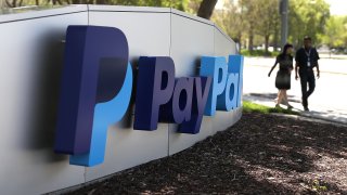 A sign is posted outside of the PayPal headquarters in San Jose, California.