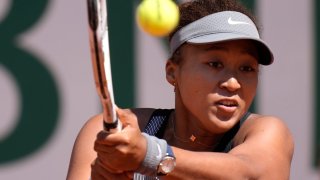 Japan's Naomi Osaka returns the ball to Romania's Patricia Maria Tig during their first round match of the French open tennis tournament