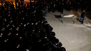 Mourners gather around the body of Menachem Knoblowitz, 21, from the United States, who died during Lag BaOmer celebrations at Mt. Meron in northern Israel