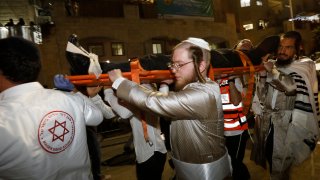 Israeli emergency services transport the injured following a bleacher collapse at a synagogue in the Israeli settlement of Givat Zeev southeast of Ramallah city in the occupied West Bank