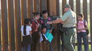 United States Border Patrol agents detain families from Central and South America who have been crossing into the United States from Mexico to ask for asylum, April 30, 2021 outside of Yuma, Arizona.