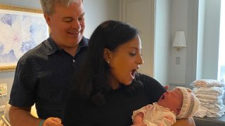 Kristen Welker and husband John Hughes with baby Margot.