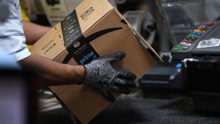 A worker assembles a box for delivery at the Amazon fulfillment center in Baltimore, Maryland, U.S., April 30, 2019.