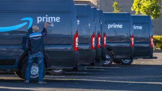 A contractor working for Amazon.com cleans a delivery truck in Richmond, California, U.S., on Tuesday, Oct. 13, 2020.