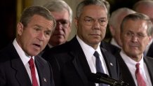 US President George W. Bush (L) speaks before signing the joint congressional resolution authorizing US use of force against Iraq if needed, 16 October 2002, at the White House in Washington, DC. From L are House Speaker Dennis Hastert (R-IL), Secretary of State Colin Powell and Secretary of Defense Donald Rumsfeld.