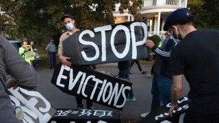 housing activists erect a sign in Swampscott, Mass.
