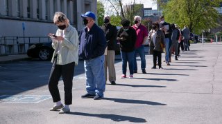 People line up outside a newly reopened career center for in-person appointments in Louisville, Kentucky, on April 15, 2021.