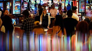 crowds walk through the casino during the opening night of Resorts World Las Vegas in Las Vegas