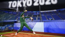 Mexico's Dallas Escobedo warms up before a softball game against Italy at the 2020 Summer Olympics