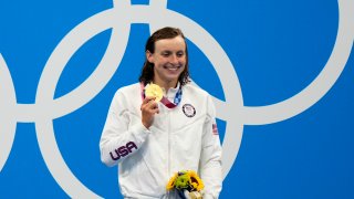 Katie Ledecky, of United States, poses after winning the gold medal in the women's 800-meter freestyle final at the 2020 Summer Olympics, Saturday, July 31, 2021, in Tokyo, Japan.