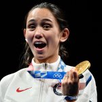 Gold medallist USA's Lee Kiefer celebrate on podium during the medal ceremony for the women's foil individual during the Tokyo 2020 Olympic Games at the Makuhari Messe Hall in Chiba City, Chiba Prefecture, Japan, on July 25, 2021.