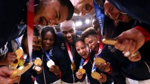 Team France celebrates with the gold medal during the podium ceremony for the judo mixed team of the Tokyo 2020 Olympic Games at the Nippon Budokan in Tokyo on July 31, 2021.