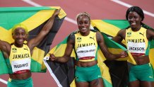 From left: Jamaica's runner-up Shelly-Ann Fraser-Pryce, first-place finisher Elaine Thompson Herah and third-place finisher Shericka Jam Jackson celebrate with flags after the women's 100-meter, July 31, 2021, Tokyo, Japan.
