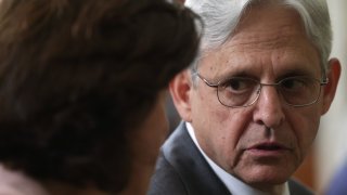 WASHINGTON, DC - JULY 09: U.S. Attorney General Merrick Garland (R) talks to Secretary of Commerce Gina Raimondo (L) as they wait for the beginning of an event at the State Dining Room of the White House July 9, 2021 in Washington, DC. President Joe Biden signed an executive order on “promoting competition in the American economy.”