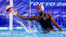 Ashleigh Johnson stops a goal in Olympic waterpolo