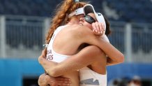 Kelly Claes #1 of Team United States celebrates with Sarah Sponcil #2 after defeating Team Brazil during the Women's Preliminary - Pool D beach volleyball on day eight of the Tokyo 2020 Olympic Games at Shiokaze Park on July 31, 2021, in Tokyo, Japan.