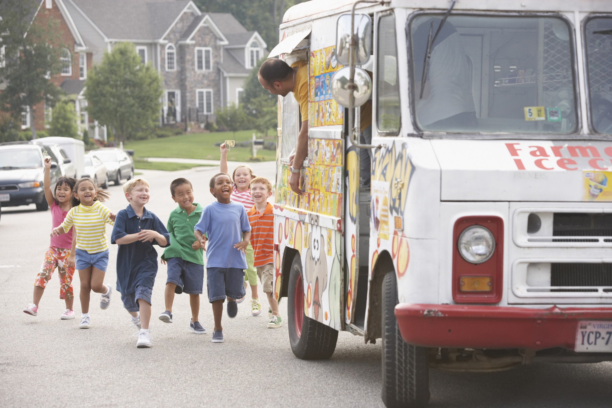 Children running towards an ice cream truck