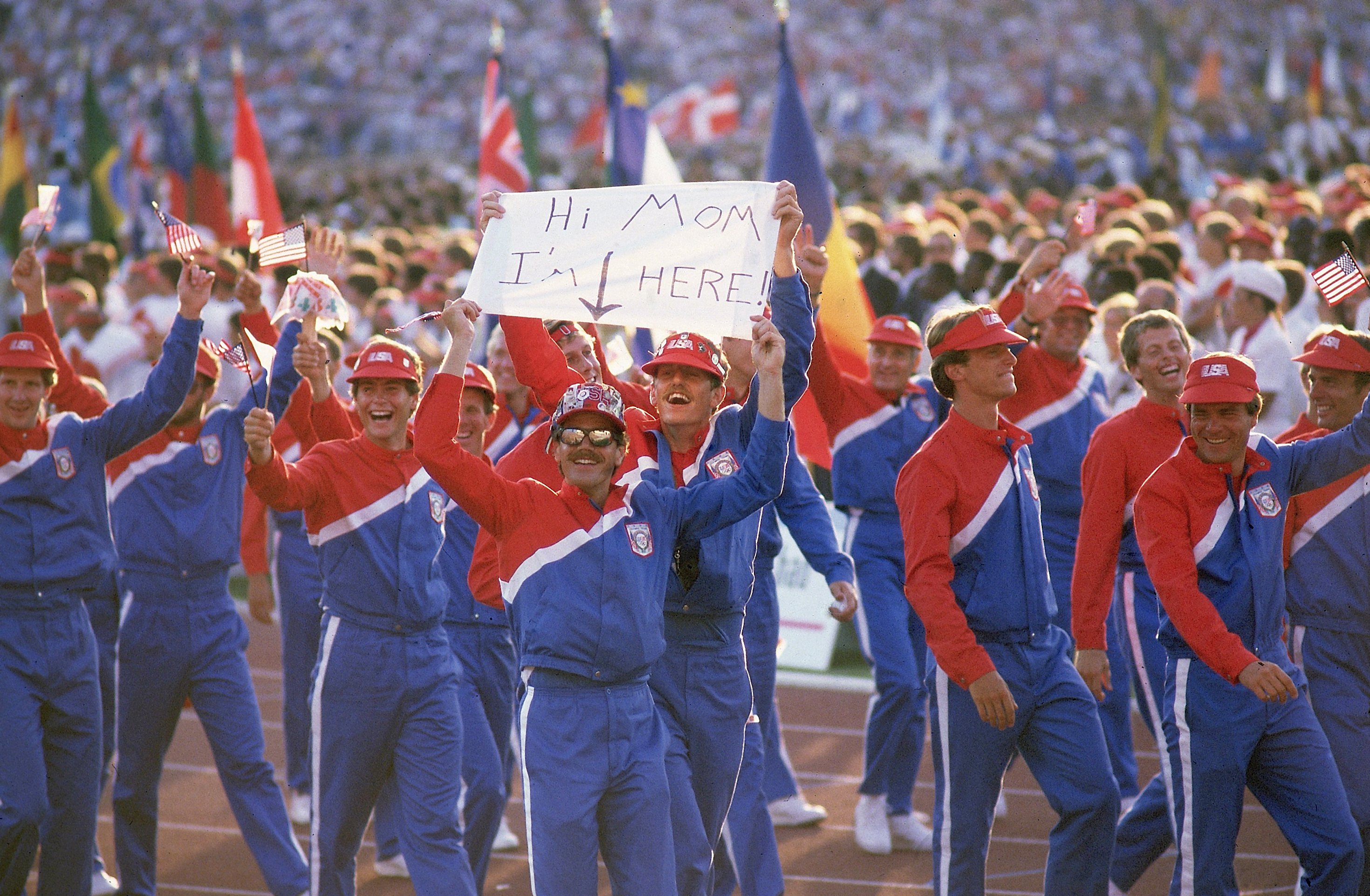 Team USA athletes, including one with a 'Hi Mom' sign, walk in their delegation during the procession at Memorial Coliseum. CREDIT: Manny Millan (Photo by Manny Millan /Sports Illustrated via Getty Images) (Set Number: X30348 )