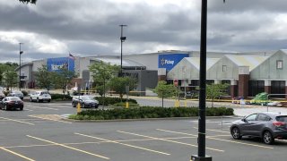 Walmart with a police car and crime scene tape up in the parking lot
