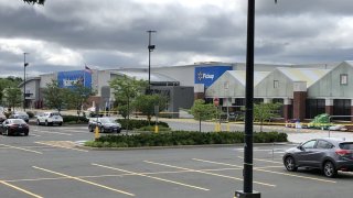 Walmart with a police car and crime scene tape up in the parking lot