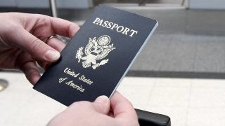 A passenger holds her U.S. passport