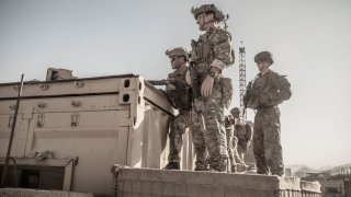U.S. service members assist at an Evacuation Control Check Point (ECC) during an evacuation at Hamid Karzai International Airport, Kabul, Afghanistan, August 26, 2021.
