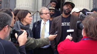 Robert Jones and defense attorneys with reporters