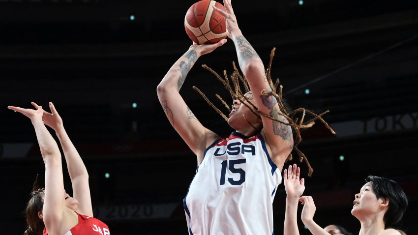 USA's Brittney Griner takes a shot past Japan's Yuki Miyazawa (L) in the women's final basketball match between USA and Japan during the Tokyo 2020 Olympic Games at the Saitama Super Arena in Saitama on Aug. 8, 2021.