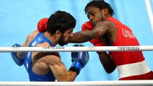 Keyshawn Davis of Team United States (red) exchanges punches with Hovhannes Bachkov of Team Armenia during the Men's Light (57-63kg) Semifinal 1 on day fourteen of the Tokyo 2020 Olympic Games at Kokugikan Arena on Aug. 6, 2021 in Tokyo, Japan.