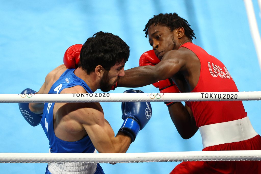 Keyshawn Davis of Team United States (red) exchanges punches with Hovhannes Bachkov of Team Armenia during the Men's Light (57-63kg) Semifinal 1 on day fourteen of the Tokyo 2020 Olympic Games at Kokugikan Arena on Aug. 6, 2021 in Tokyo, Japan.