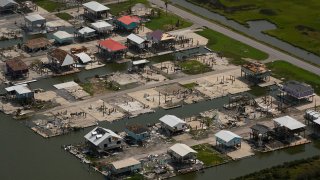 In this aerial photo, the remains of damaged homes are seen in the aftermath of Hurricane Ida, Monday, Sept. 6, 2021, in Grand Isle, La.