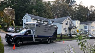 Connecticut State Police van in front of a gray house.