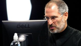 Apple CEO Steve Jobs uses a Dell PC computer to demonstrate the new iTunes for Windows October 16, 2003 in San Francisco. Jobs announced the popular iTunes music program would now be able to be used on both Apple and PC computers.