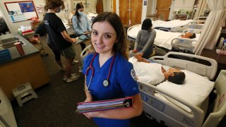 Nursing student Emma Champlin poses for a photo in her clinical laboratory class