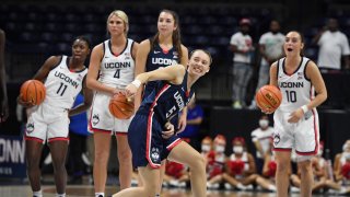 Connecticut's Paige Bueckers reacts after a shot from half-court during First Night events for the UConn men's and women's NCAA college basketball teams Friday, Oct. 15, 2021, in Storrs, Conn.