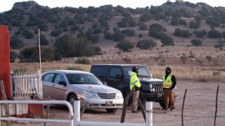 Security stands at the entrance to a film set where police say actor Alec Baldwin fired a prop gun, killing a cinematographer, is seen outside Santa Fe, New Mexico, Friday, Oct. 22, 2021. The Bonanza Creek Ranch film set has permanent structures for background used in Westerns, including "Rust," the film Baldwin was working on when the prop gun discharged.