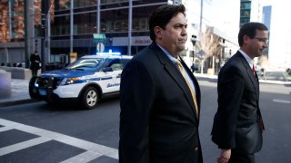 William Ferguson, left, former women's volleyball coach at Wake Forest University, is pictured outside the John Joseph Moakley United State Courthouse in Boston on March 25, 2019.