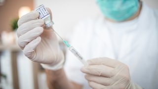 The doctor talks to the older woman and explains to her the safety of the vaccine itself and its effects. Immunization against the Coronavirus pandemic.