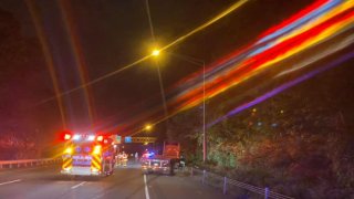 emergency vehicles on side of highway