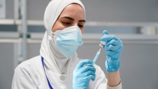 A nurse prepares a syringe with a dose of the Moderna coronavirus disease (COVID-19) vaccine at Enfermera Isabel Zendal hospital in Madrid, Spain, July 23, 2021.