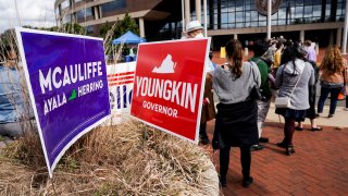 People wait in line on the last day of early voting in the Virginia gubernatorial election in Fairfax, Virginia, October 30, 2021.