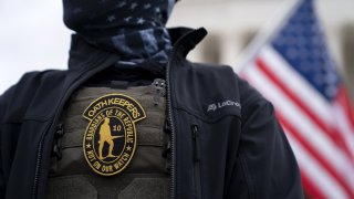 A demonstrator wears an Oath Keepers anti-government organization badge on a protective vest during a protest outside the Supreme Court in Washington, D.C., U.S., on Tuesday, Jan. 5, 2021.