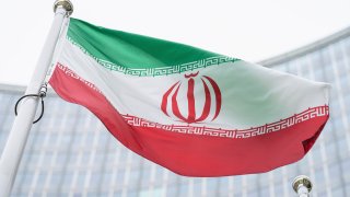 the flag of Iran waves in front of the the International Center building with the headquarters of the International Atomic Energy Agency, IAEA, in Vienna, Austria