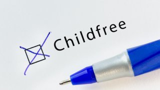 Childfree - checkbox with a cross on white paper with blue pen.