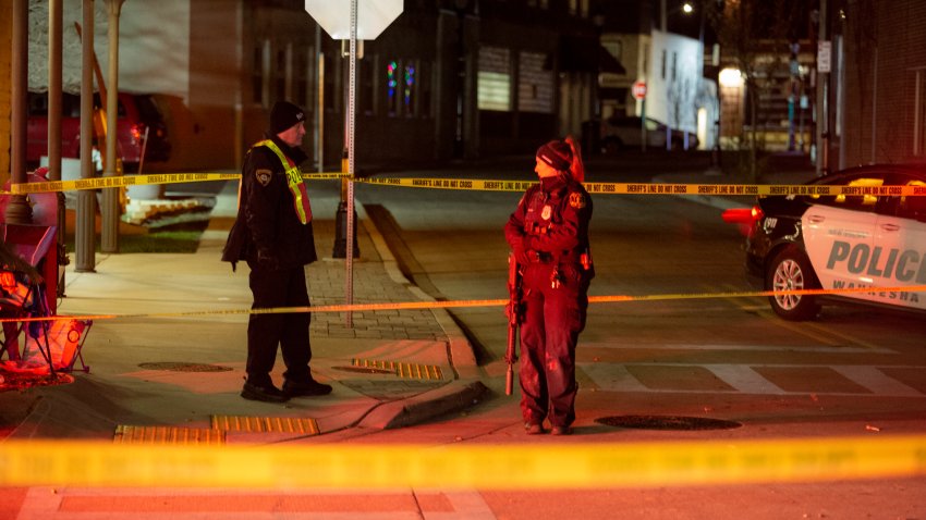 WAUKESHA, WI – NOVEMBER 21: Police and emergency personnel work on a crime scene on November 21, 2021 in Waukesha, Wisconsin. According to reports, an SUV drove through pedestrians at a holiday parade, killing at least one and injuring 20 more. (Photo by Jim Vondruska/Getty Images)