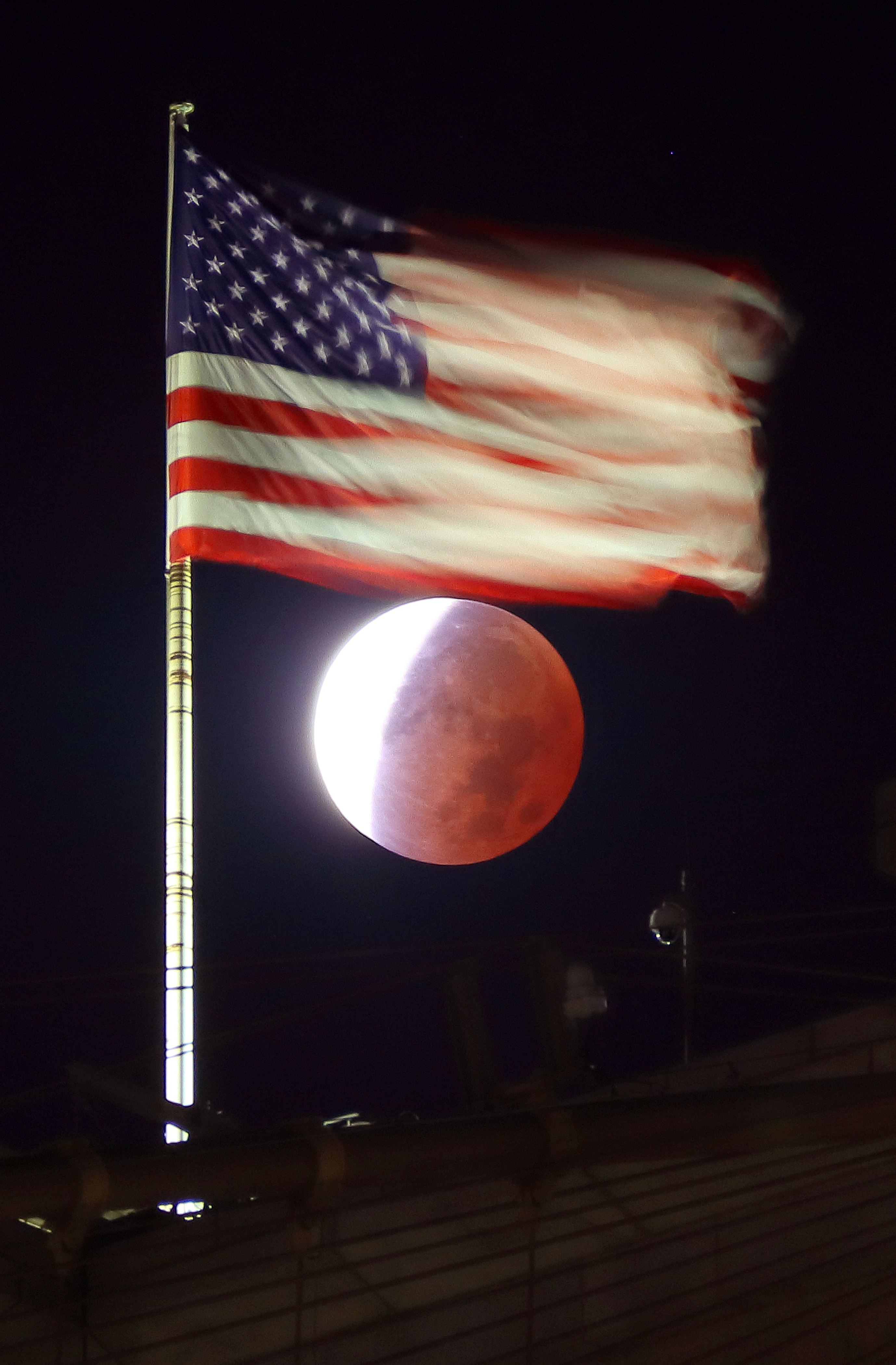 The Beaver Moon turned red during a partial lunar eclipse over the Brooklyn Bridge in New York City.