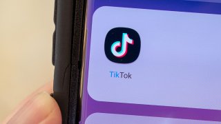 Close-up of hand holding a cellphone displaying icon for the TikTok video sharing app, Lafayette, California, September 22, 2021.