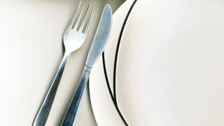 knife and fork with modern dinner plate on white