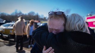 Tamara Yekinni hugs a friend outside a shelter in Wingo